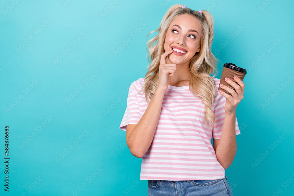 Photo of gorgeous positive person finger touch chin hold coffee cup look empty space isolated on teal color background Photo of gorgeous positive person finger touch chin hold coffee cup look empty space isolated on teal color background