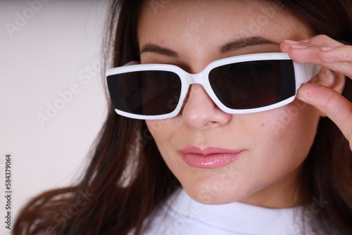 Close up portrait of young woman wearing glamour sun glasses
