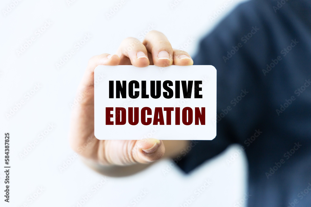 Inclusive learning text on blank business card being held by a woman's hand with blurred background. Business concept about inclusive learning. Inclusive learning text on blank business card being held by a woman's hand with blurred background. Business concept about inclusive learning.