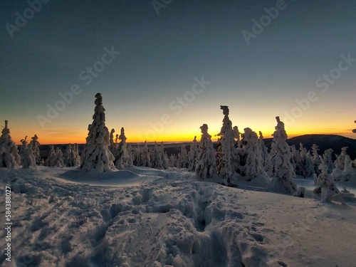 Hike to mountain Smrk in Beskydy, Czech; sunshine in mountains, forest with snow
