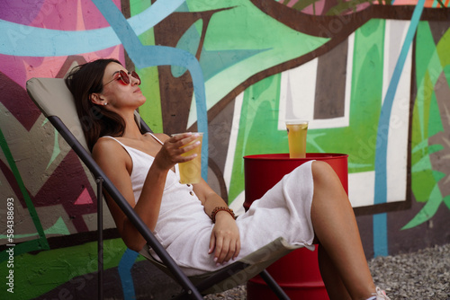 girl drinking a cocktail on a summer terrace, lifestyle photo