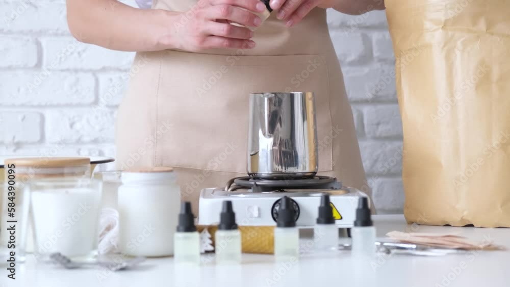 Woman making decorative aroma candle at table, closeup Woman making decorative aroma candle at table, closeup