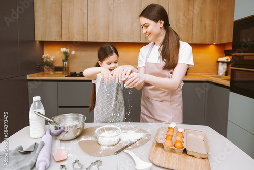 happy family in the kitchen. mother and daughter prepare dough, bake cookies, Easter cake.