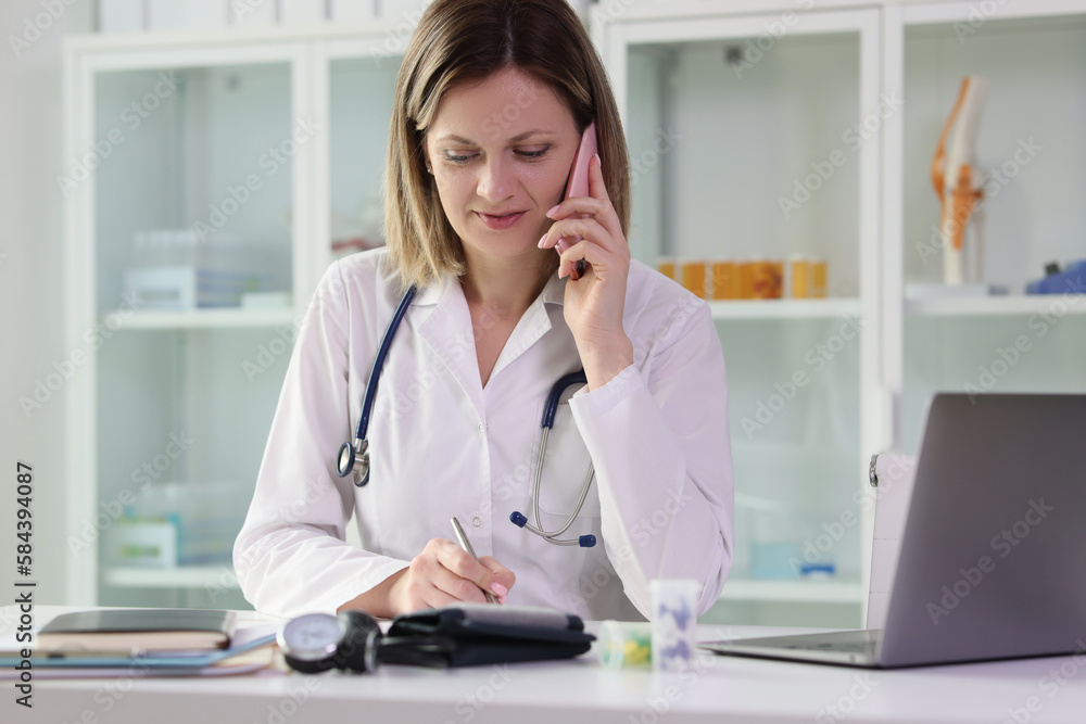 Doctor does phone call with patient to give consultation Doctor does phone call with patient to give consultation