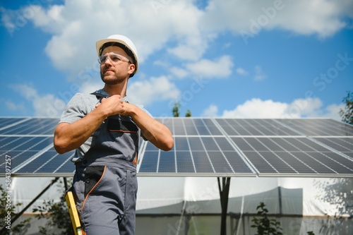 A man working at solar power station. © Serhii