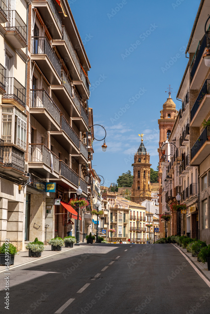 City center of beautiful Spanish city Antequera. Touristic travel destination in Andalucía. View of main street. In background is the Cathedral tower. Vertical photo