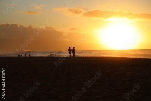 silhouette of a couple walking on the beach