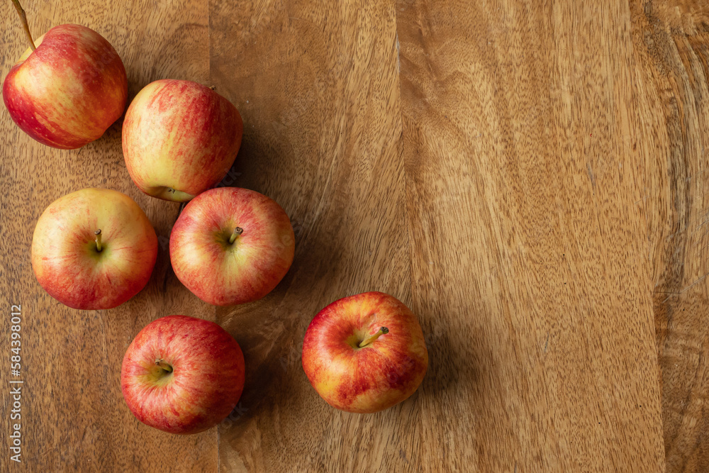 Bird's perspective on red apples and rustic table background with copy space. Apple culltivar gala with a sweet, mild flavour ad crisp texture rich in vitamin c, b, k and contains dietary fiber. Bird's perspective on red apples and rustic table background with copy space. Apple culltivar gala with a sweet, mild flavour ad crisp texture rich in vitamin c, b, k and contains dietary fiber.
