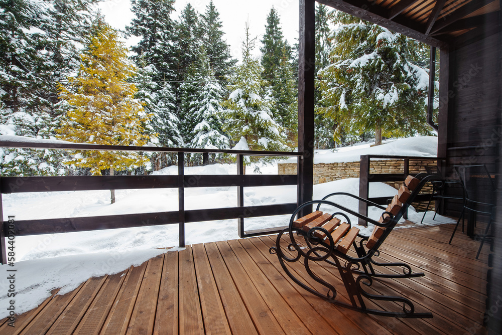 Armchair on the terrace of the Alpine Chalet house in the mountains
