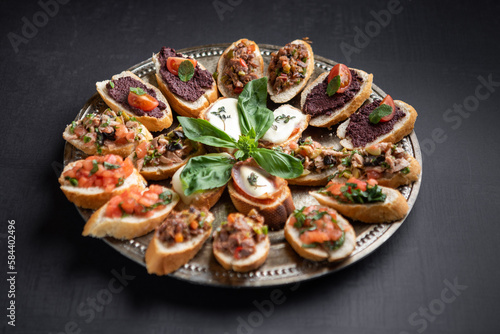 Festive platter with appetizers decorated with flowers, berries and microgreen