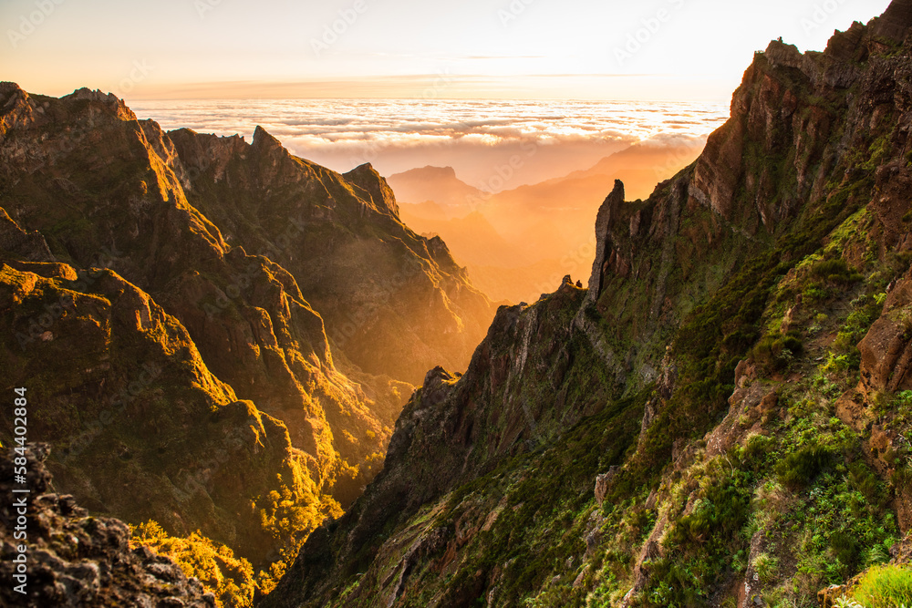 Beautiful sunrise in Madeira highest mountains range. Hiking trial from Pico do Areerio to Pico do Ruivo. Madeira, Portugal