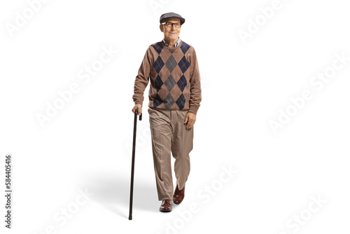Full length portrait of an elderly man with a cane walking towards camera