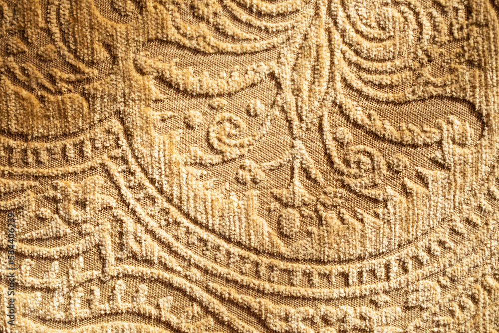 golden, tan embroidered upholstery fabric