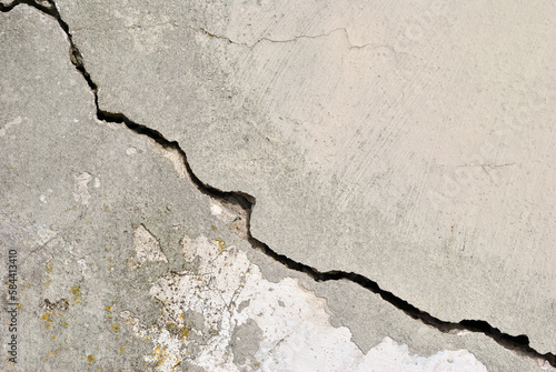 Close Up of Old Grey Cement Wall with Large Diagonal Crack
