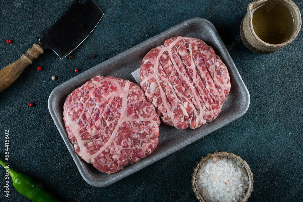 Raw minced meat and ingredients for home made grill burgers. Semifinished food. American cuisine. Raw burger Raw minced meat and ingredients for home made grill burgers. Semifinished food. American cuisine. Raw burger