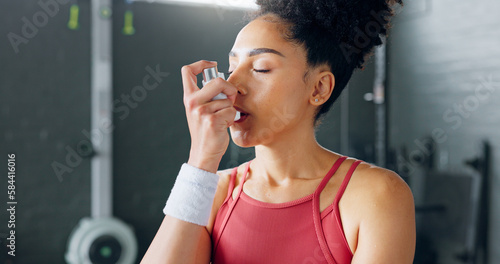 Exercise woman, asthma inhaler breathe at gym with fitness coach for chest relief and wellness. Black woman anxiety, asma attack sitting on floor at training workout for body health in Los Angeles photo