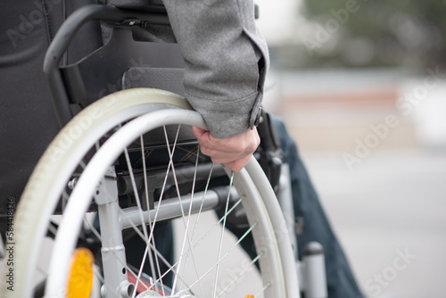 a hand on a wheelchair
