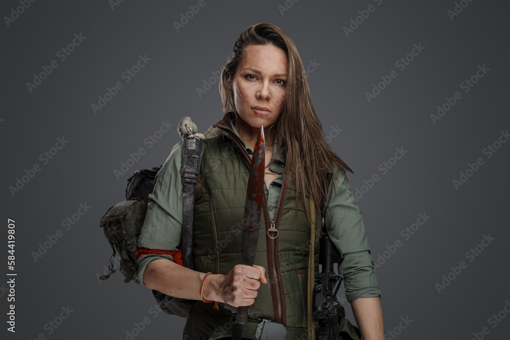 Shot of Mercenary woman in setting of post apocalypse looking at camera.