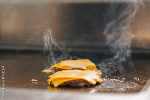 professional kitchen in hotel restaurant close up smash burger with grilled cheese food concept