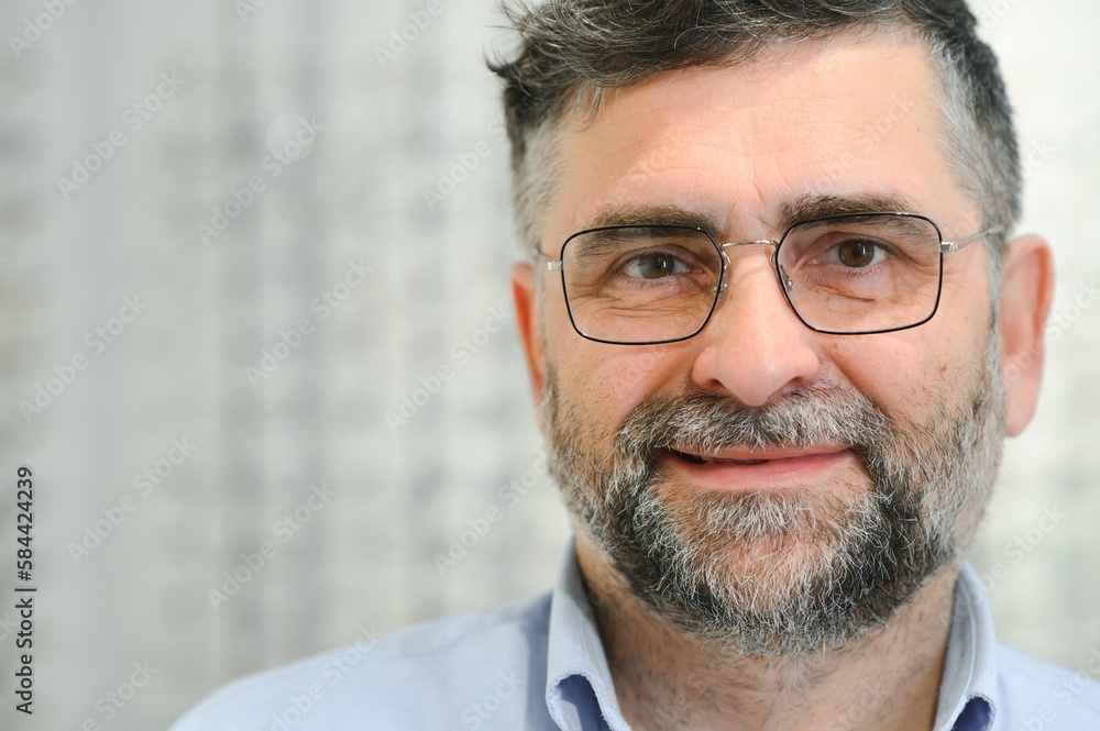 Senior man choosing glasses in optical store, try on eyeglass frames to decide on the perfect one Senior man choosing glasses in optical store, try on eyeglass frames to decide on the perfect one