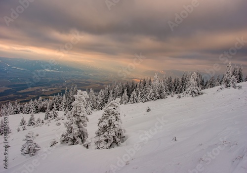 Fantastic evening winter landscape. Dramatic overcast sky. Beauty world. Hiking in the mountains, a healthy lifestyle