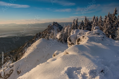 Fototapeta Naklejka Na Ścianę i Meble -  Winter hiking in slovakia mountains. View from the hills. Ostra, tlsta Peak, Velka Fatra. Slovakia. Hiking in the mountains, a healthy lifestyle