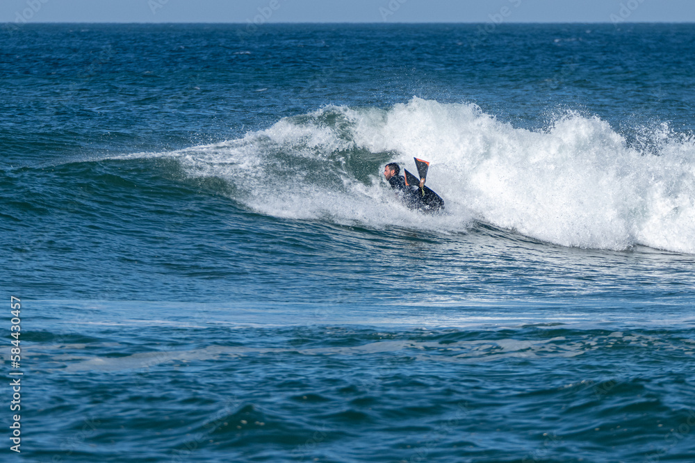 Bodyboarder surfing ocean wave