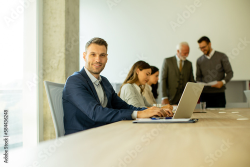 Young business man using laptop computer in the office