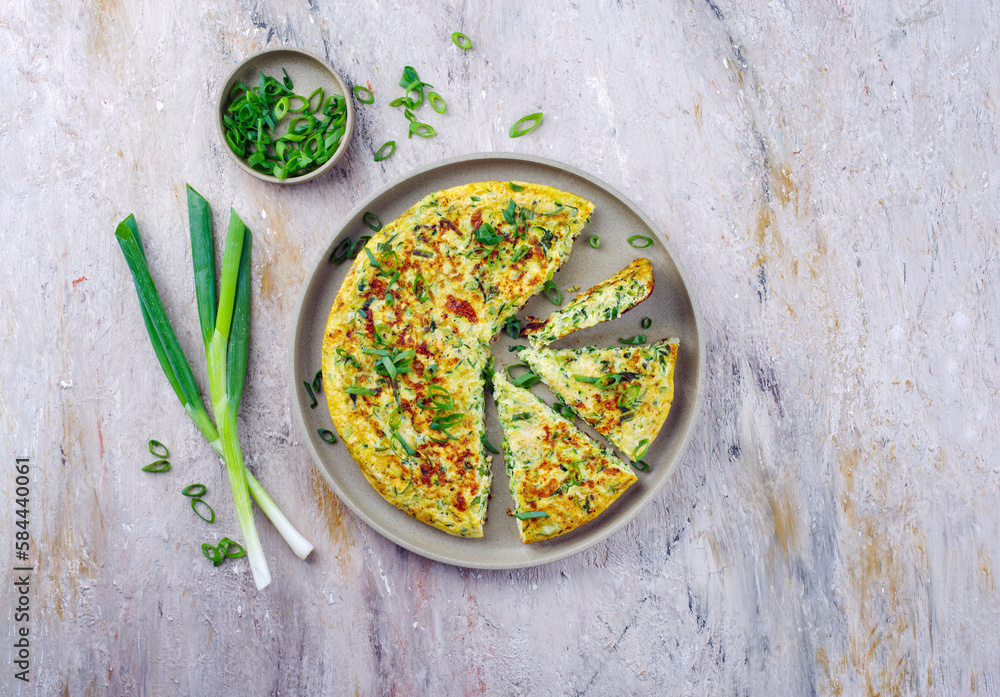 Traditional Italian vegetable frittata with zucchini, spring onion and cheese served as top view on Nordic design plate with text space - obrazy, fototapety, plakaty 