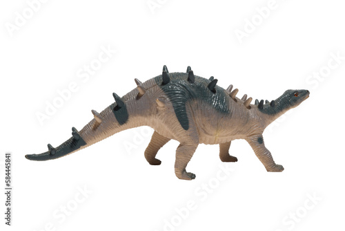 A worn out dinosaur toy with spikes on its back isolated on white background. kentrosaurus.