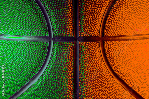 Closeup detail of basketball ball texture background. Green and orange neon. Banner Art concept © Augustas Cetkauskas