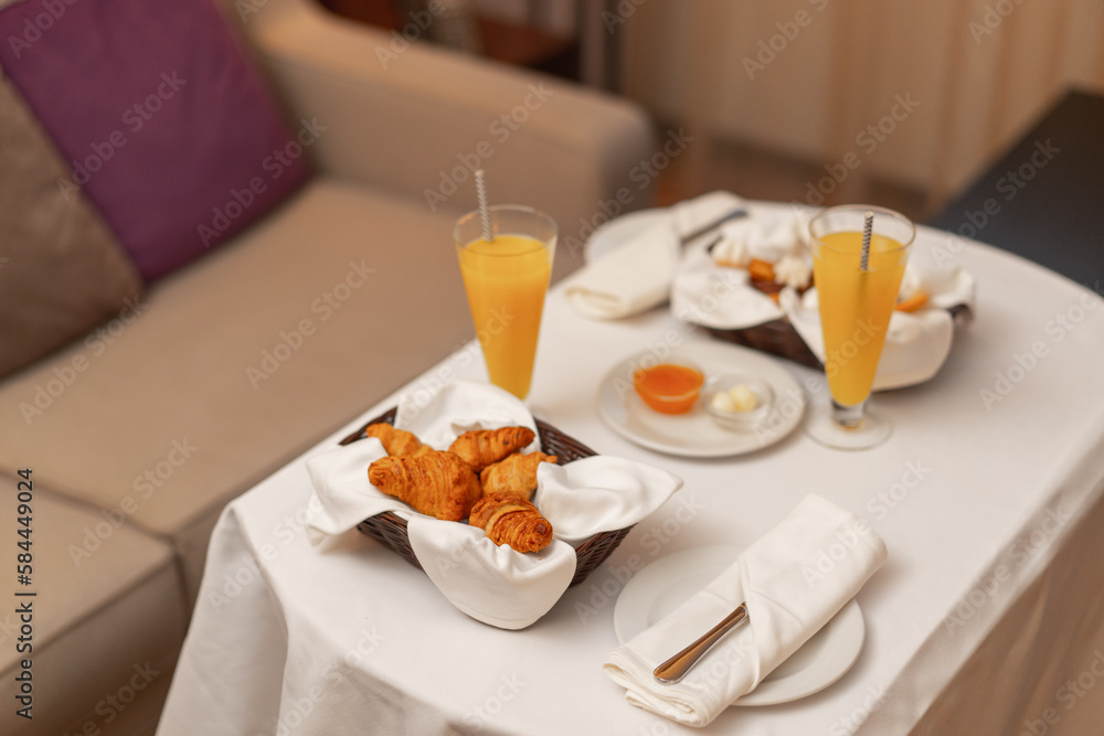 Early in the morning, a waiter brings a cart with a sumptuous breakfast to the hotel room Hotel food service
