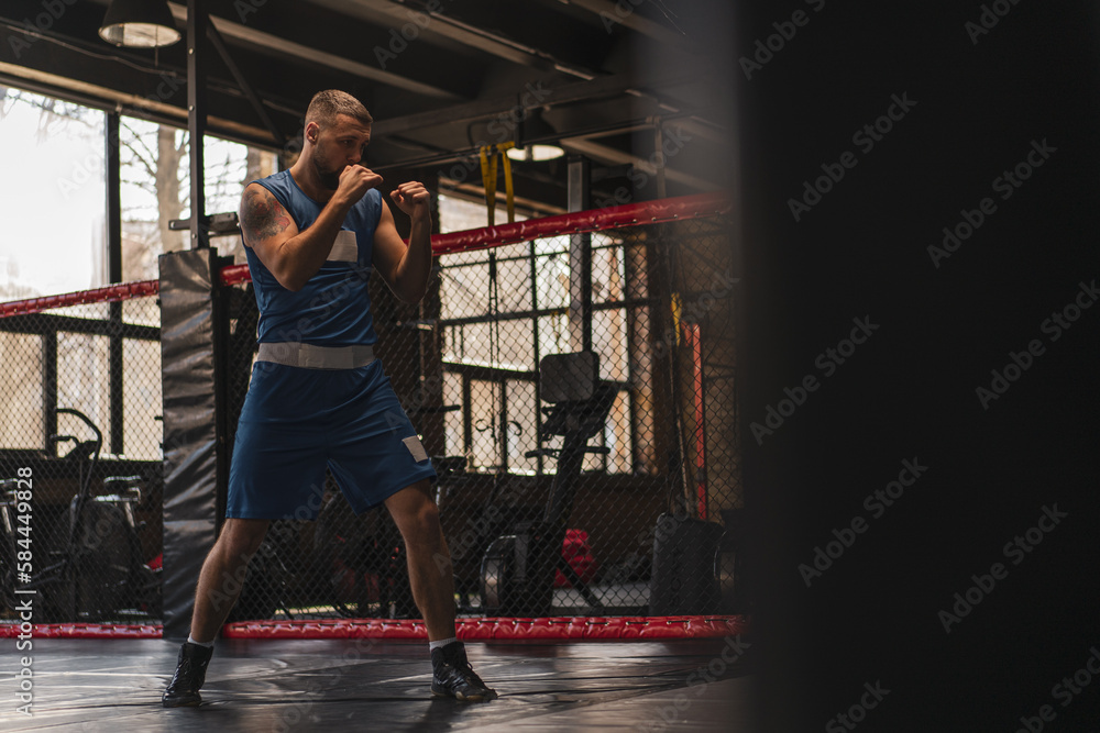 Obraz premium A boxer in the gym who fights with the shadow practices punches