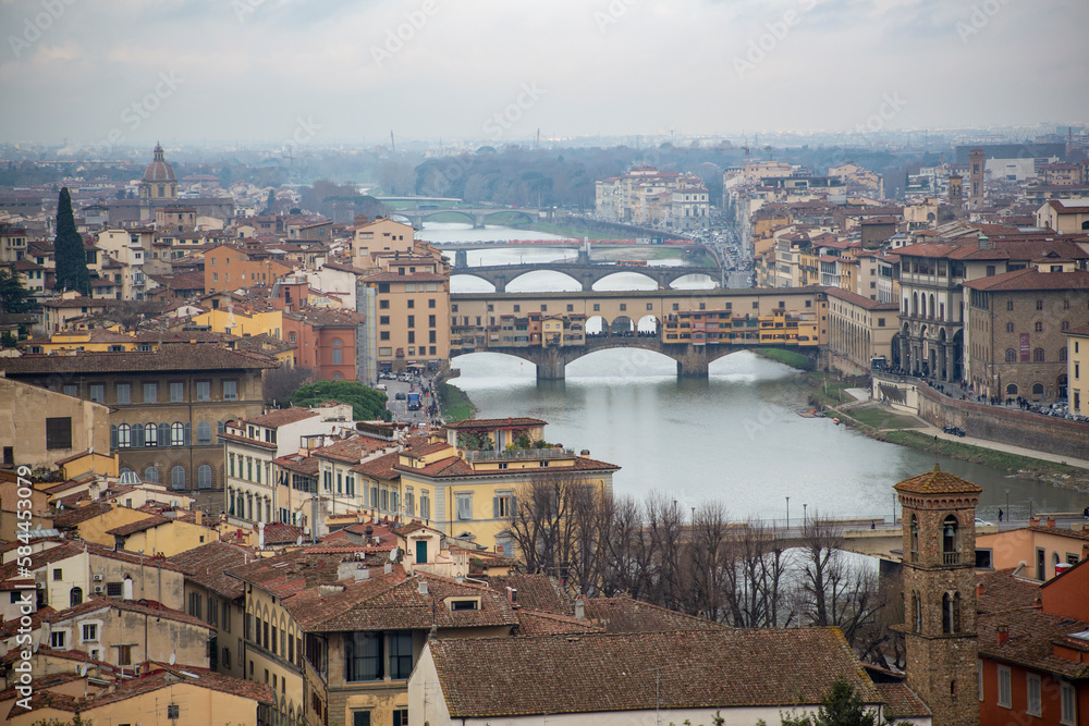 View from the top of the city of Florence including the Ponte Vecchio on the Arno river in the middle of the city, Italy