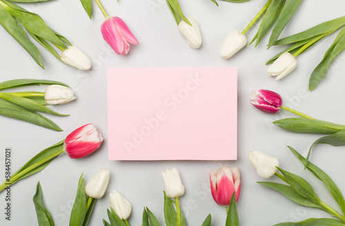 Fototapeta Naklejka Na Ścianę i Meble -  Bright tulips on color background, top view. Greeting card mockup