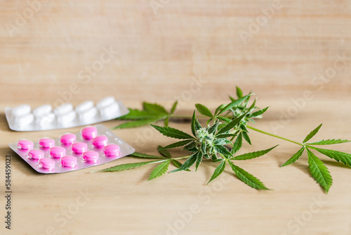 Fototapeta Naklejka Na Ścianę i Meble -  Marijuana buds flowers and prescription pills on table.