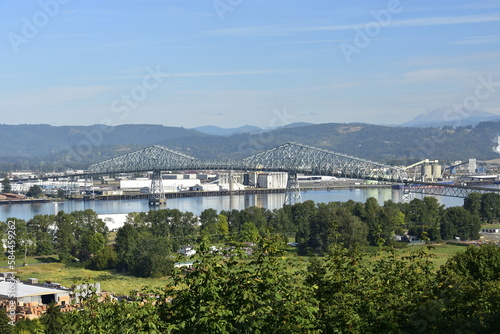 Loading logs for export on the Columbia River, at port of Longview, WA. Mt. St Helens in distance.