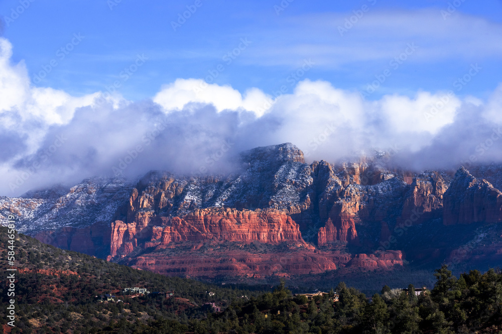Puffy clouds loom over the hills of Sedona, AZ