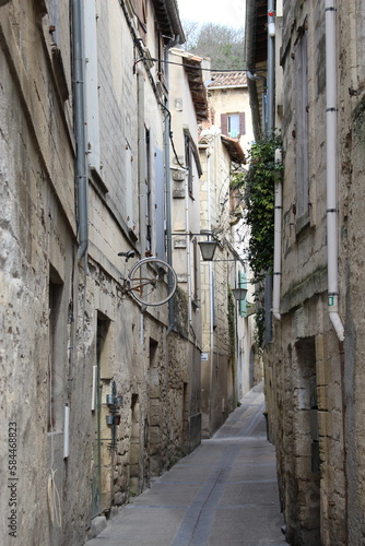 A typical  ancient  narrow stone street in a small French town in Occitania  Sommi  res. Passageway seen in winter