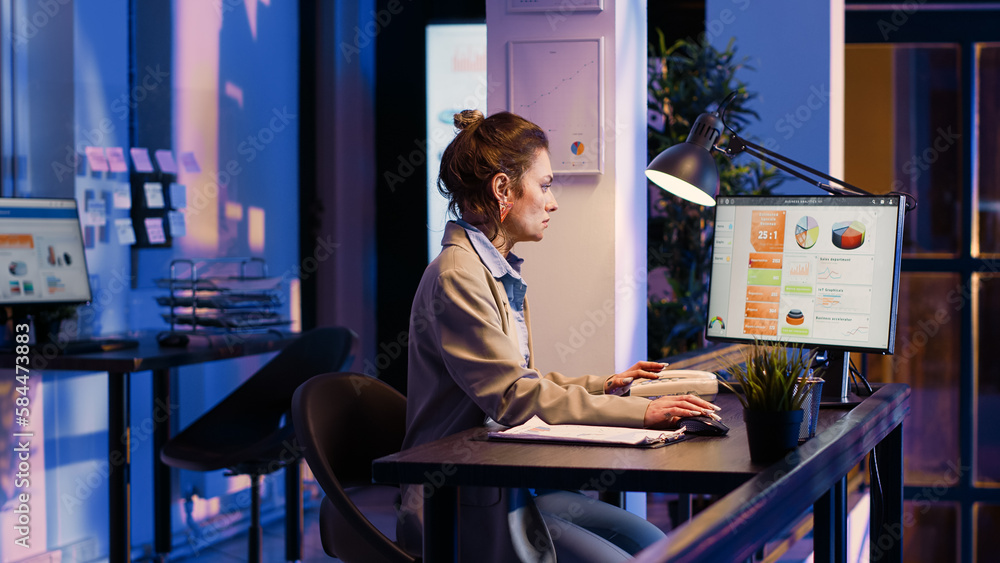 Young worker analyzing documents with statistics in corporate office, working to create financial business graphs report. Woman planning analytics project to increase profit. Tripod shot. Young worker analyzing documents with statistics in corporate office, working to create financial business graphs report. Woman planning analytics project to increase profit. Tripod shot.