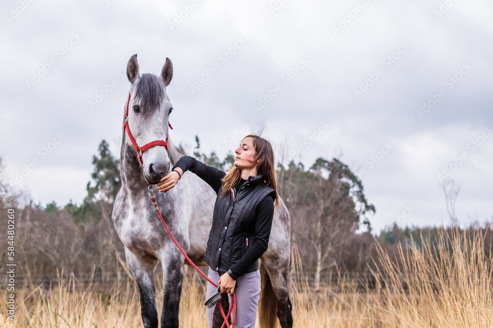 andalusian pure spanish horse. hispanic middle aged woman from horse