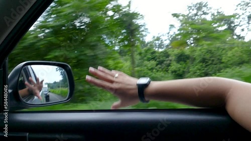 Hand of a Woman Playing at the Car Window 
