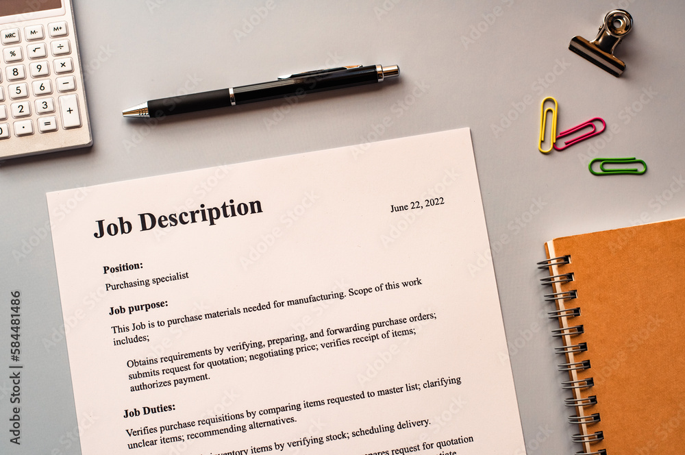 There is dummy documents that created for the photo shoot on the desk about Job Description.