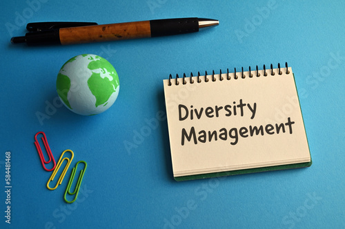 There is a notebook with the word Diversity Management. It is eye-catching image.