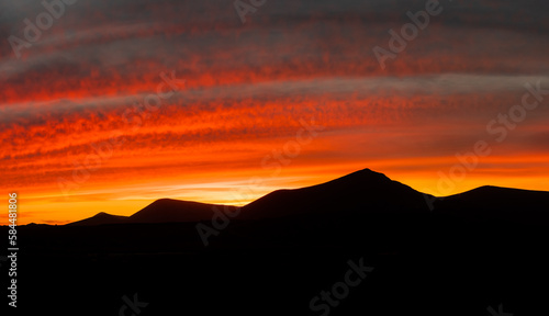 Beautiful and dramatic sunset colours over the volcanic mountain range near Corralejo in Fuerteventura Canary Islands Spain