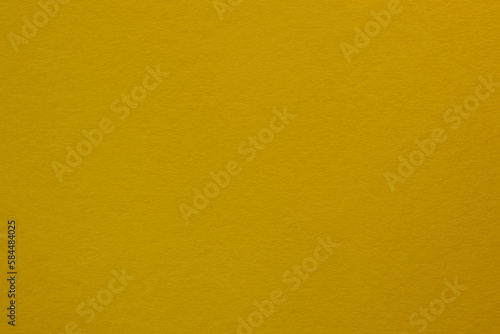 Mustard yellow colored tinted paper texture swatch.