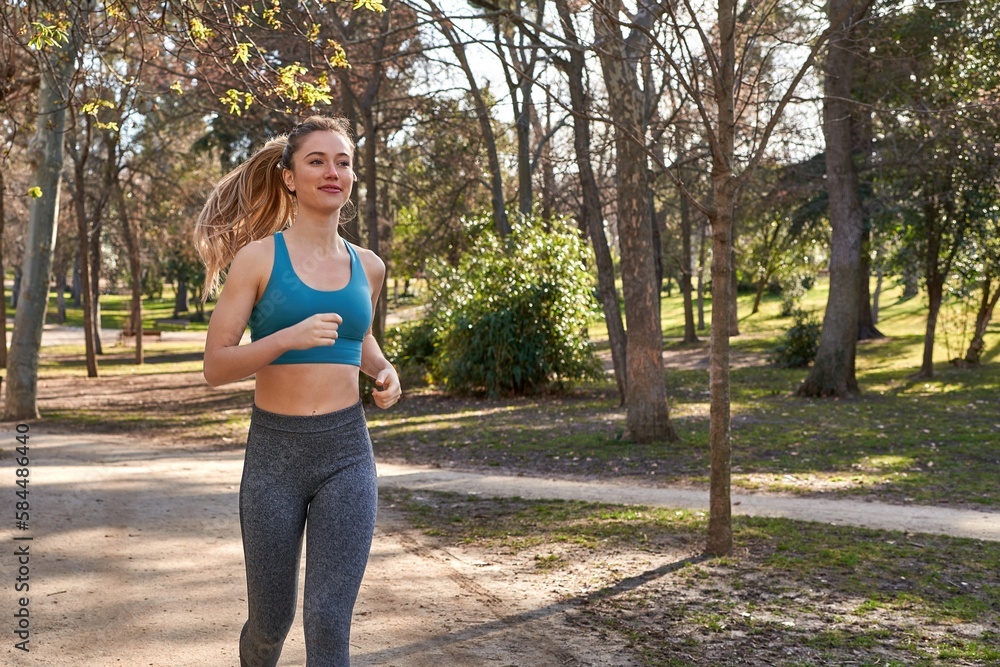 Young caucasian woman embraces the outdoors with her running routine. Young caucasian woman embraces the outdoors with her running routine.