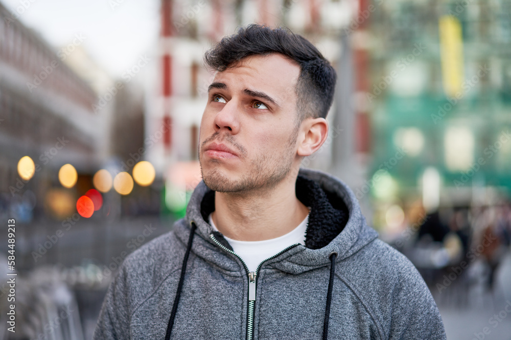Young man lost in thought, surrounded by the enchanting lights of the city at night. Young man lost in thought, surrounded by the enchanting lights of the city at night.