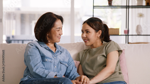 Middle aged asia people old mom love care trust comfort help young teen talk crying stress relief at home. Mum as friend listen adult child woman feel pain sad worry of broken heart life crisis issues