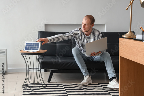 Young man with laptop and p...
